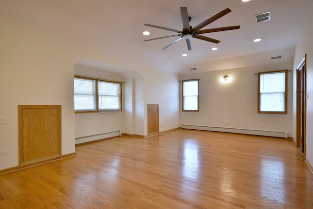 empty room featuring baseboard heating, a ceiling fan, and visible vents
