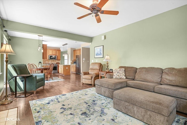 living room with a ceiling fan and wood finished floors