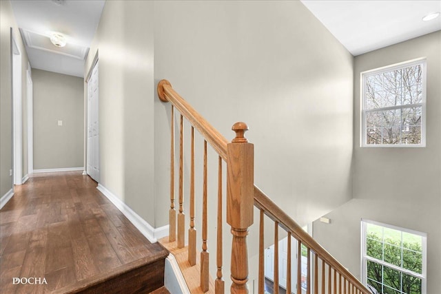 hallway featuring baseboards and wood finished floors