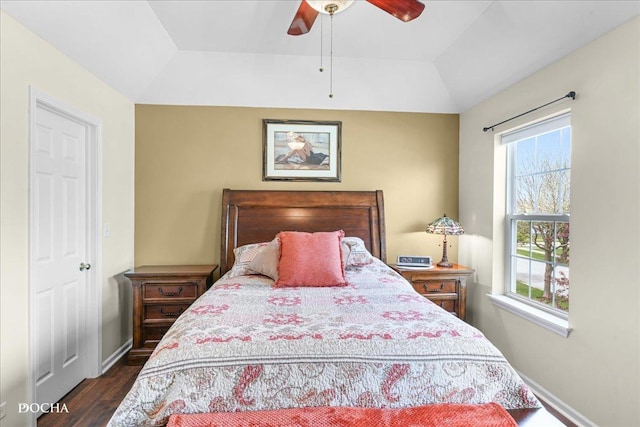 bedroom featuring baseboards, ceiling fan, dark wood-style floors, and lofted ceiling