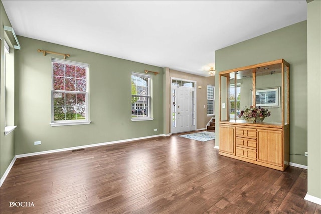 entrance foyer featuring baseboards, stairs, and dark wood-type flooring