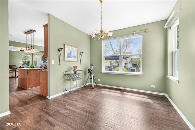 dining area with baseboards, plenty of natural light, and dark wood-style flooring