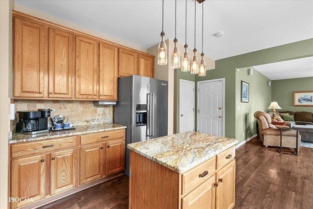 kitchen featuring dark wood-style flooring, light stone counters, open floor plan, tasteful backsplash, and pendant lighting
