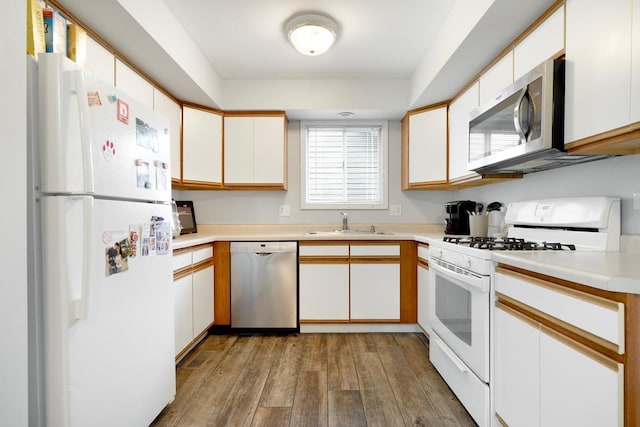 1306 Haverhill Cir, Naperville, IL 60563 - kitchen with stainless steel appliances, a sink, hardwood / wood-style floors, light countertops, and white cabinets