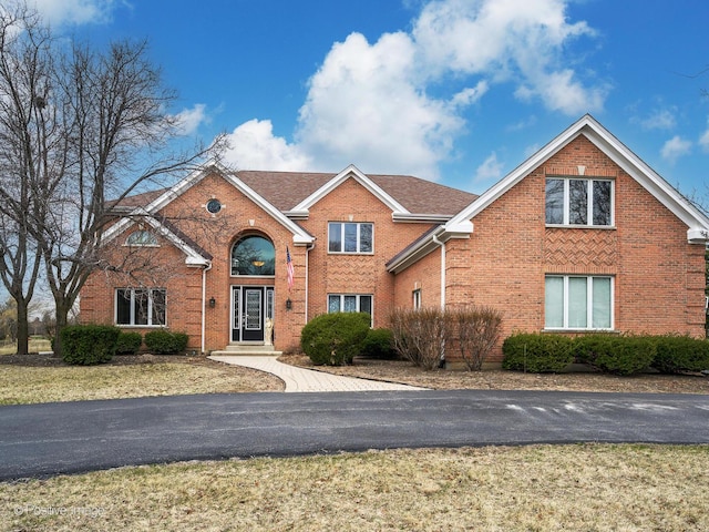 traditional-style home featuring brick siding