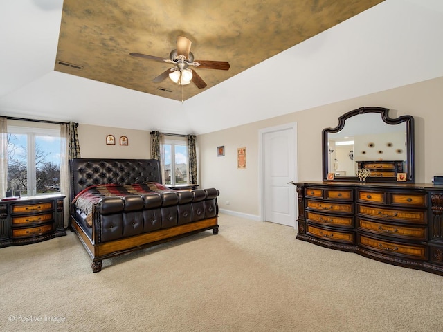 bedroom with visible vents, baseboards, carpet flooring, and a raised ceiling
