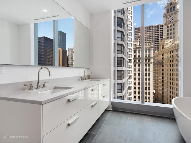 403 N Wabash Ave Unit 13B, Chicago, IL 60611 - full bathroom with a skyline view, double vanity, a freestanding tub, and tile patterned flooring
