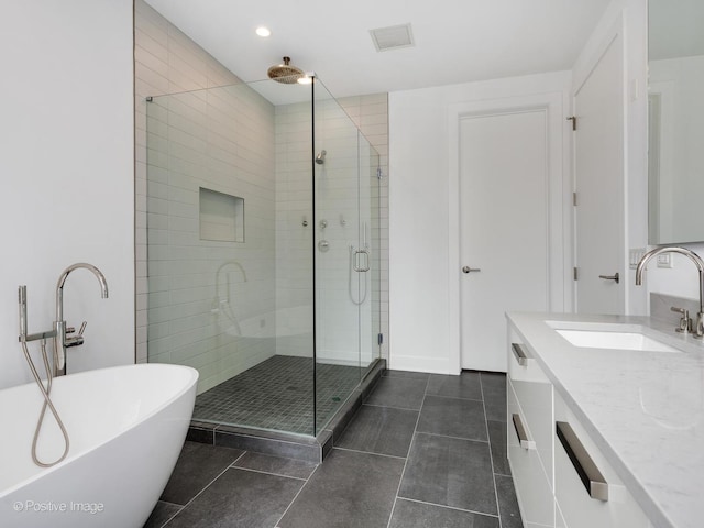 403 N Wabash Ave Unit 13B, Chicago, IL 60611 - full bath featuring a stall shower, a freestanding bath, vanity, tile patterned flooring, and recessed lighting