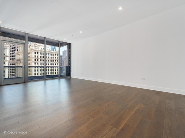403 N Wabash Ave Unit 13B, Chicago, IL 60611 - spare room with wood finished floors, recessed lighting, a wall of windows, and a view of city