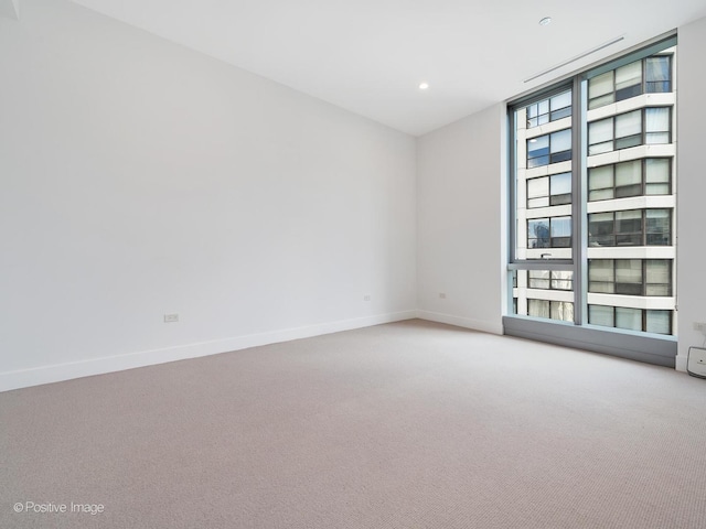 403 N Wabash Ave Unit 13B, Chicago, IL 60611 - carpeted empty room featuring baseboards and recessed lighting