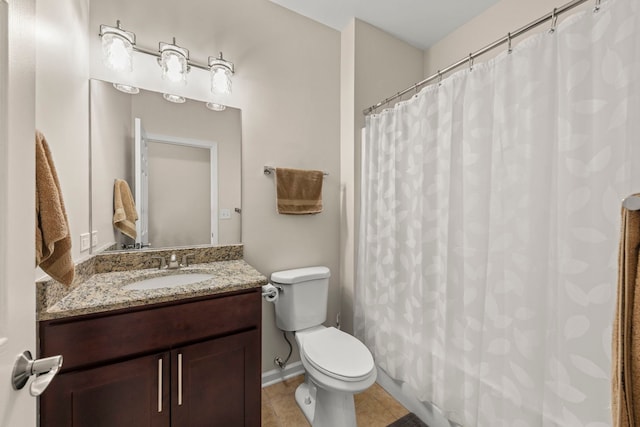 bathroom with a shower with curtain, tile patterned flooring, vanity, baseboards, and toilet