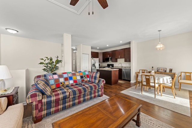 living room featuring recessed lighting, a ceiling fan, baseboards, and dark wood-style floors