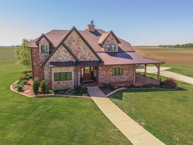 14431 E 2400 N Rd, Hudson, IL 61748 - view of front facade featuring a front lawn, a standing seam roof, a chimney, stone siding, and metal roof