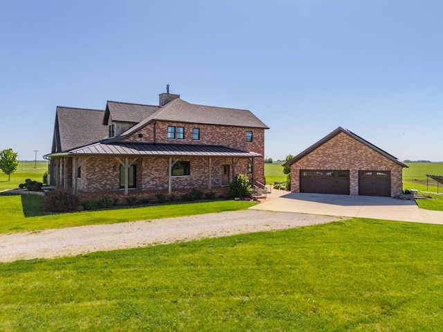 14431 E 2400 N Rd, Hudson, IL 61748 - view of front of house with dirt driveway, a standing seam roof, a chimney, a front lawn, and brick siding