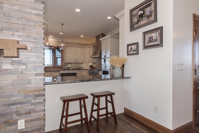 14431 E 2400 N Rd, Hudson, IL 61748 - kitchen featuring wall chimney range hood, dark stone counters, dark wood-style floors, baseboards, and decorative backsplash