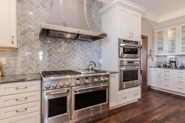 14431 E 2400 N Rd, Hudson, IL 61748 - kitchen featuring appliances with stainless steel finishes, island exhaust hood, crown molding, backsplash, and dark stone counters