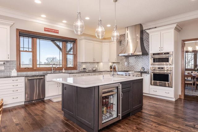 14431 E 2400 N Rd, Hudson, IL 61748 - kitchen with wall chimney exhaust hood, stainless steel appliances, wine cooler, a sink, and ornamental molding