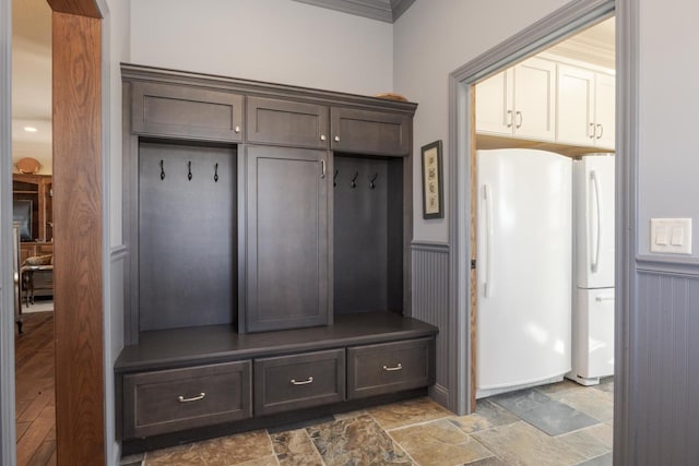 14431 E 2400 N Rd, Hudson, IL 61748 - mudroom with stone finish flooring, a wainscoted wall, and crown molding