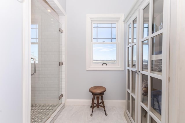 14431 E 2400 N Rd, Hudson, IL 61748 - full bathroom featuring a stall shower, baseboards, french doors, and marble look tile flooring