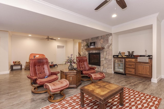 14431 E 2400 N Rd, Hudson, IL 61748 - living area with beverage cooler, a ceiling fan, crown molding, wood finished floors, and bar with sink