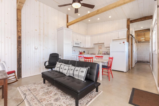 14431 E 2400 N Rd, Hudson, IL 61748 - living area with concrete floors, ceiling fan, beam ceiling, wood walls, and recessed lighting