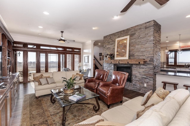 14431 E 2400 N Rd, Hudson, IL 61748 - living area with a ceiling fan, crown molding, a fireplace, wood-type flooring, and stairway
