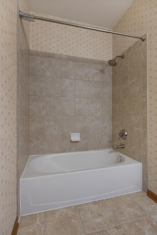 bathroom with baseboards, tile patterned floors, and bathing tub / shower combination