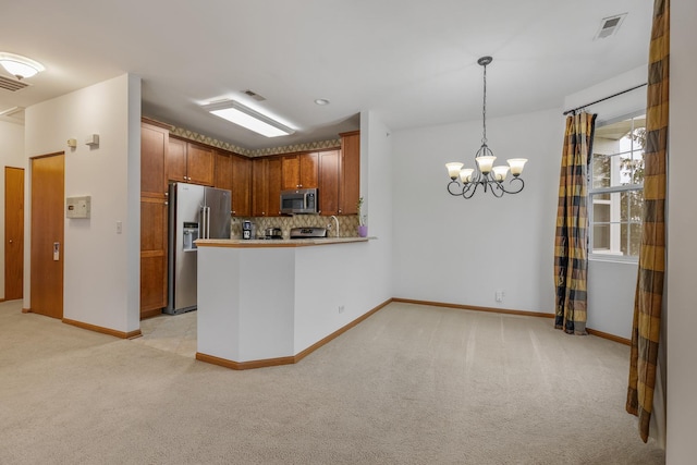 kitchen with light carpet, visible vents, appliances with stainless steel finishes, and decorative backsplash