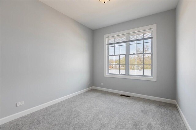 unfurnished room featuring carpet floors, a healthy amount of sunlight, and baseboards