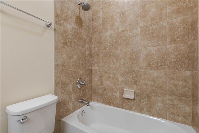 bathroom featuring shower / bathing tub combination and toilet