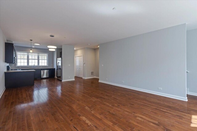 empty room featuring baseboards and dark wood-style flooring
