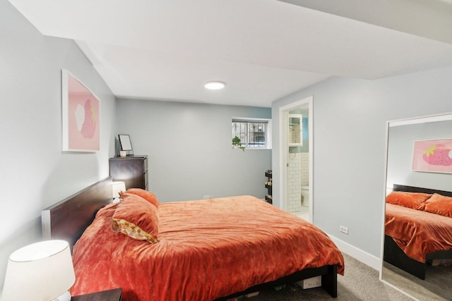 carpeted bedroom with baseboards and ensuite bathroom