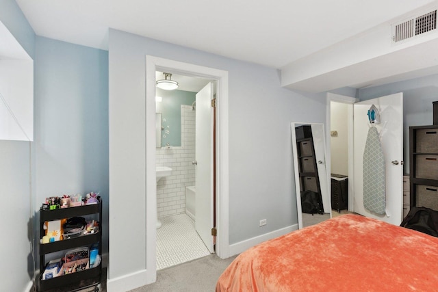 carpeted bedroom featuring baseboards and visible vents