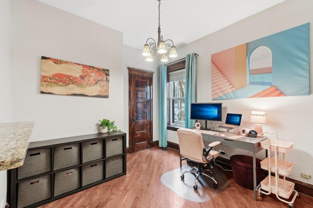 office with baseboards, a notable chandelier, and wood finished floors