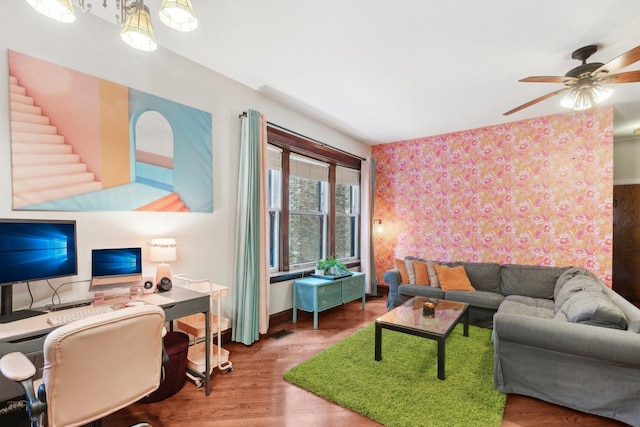 living room with baseboards, a ceiling fan, wallpapered walls, and wood finished floors