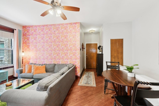 living room with a ceiling fan and wood finished floors