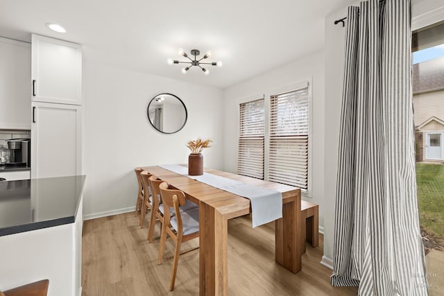 dining area with baseboards, a notable chandelier, light wood-style floors, and recessed lighting