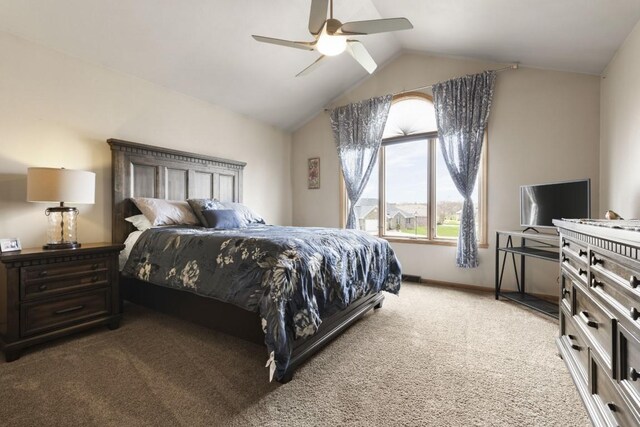 bedroom featuring light colored carpet, vaulted ceiling, a ceiling fan, and baseboards