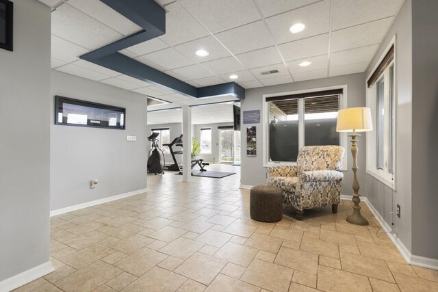 sitting room with baseboards, a drop ceiling, visible vents, and recessed lighting