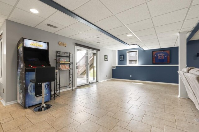 interior space featuring baseboards, visible vents, and a drop ceiling