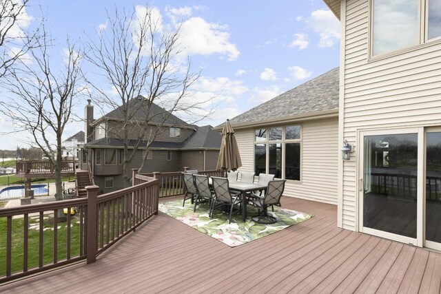 wooden terrace featuring outdoor dining space