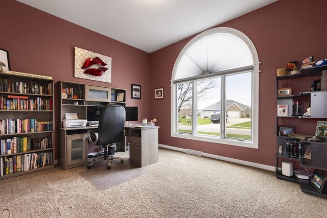carpeted office featuring baseboards