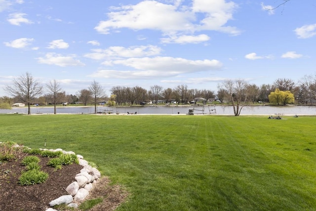 view of home's community featuring a lawn and a water view
