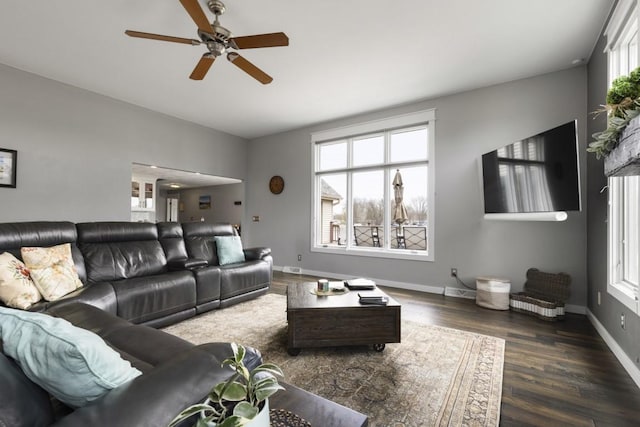 living room featuring baseboards, a ceiling fan, and wood finished floors