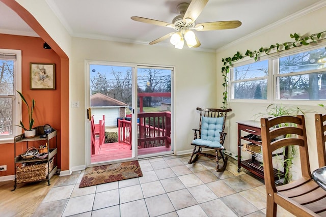 interior space featuring ceiling fan, crown molding, light tile patterned flooring, and plenty of natural light