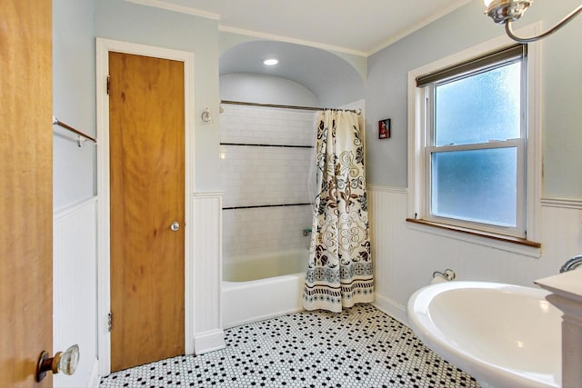 full bathroom with crown molding, shower / bath combo, and wainscoting