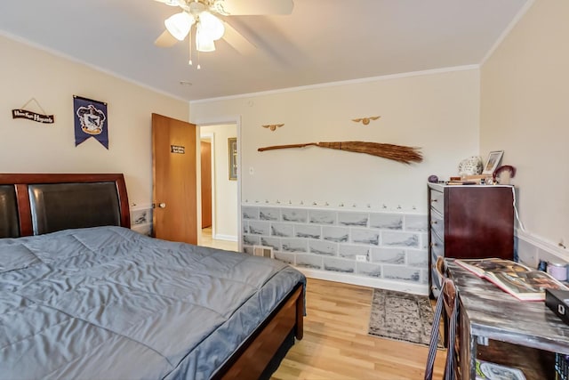 bedroom featuring a ceiling fan, wood finished floors, and crown molding