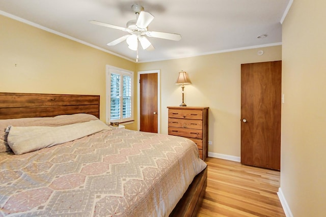 bedroom with ceiling fan, baseboards, light wood-style floors, and ornamental molding