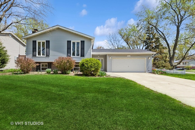 view of front of house with a front lawn, driveway, and a garage