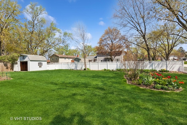 view of yard with fence, a storage unit, and an outdoor structure